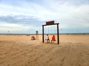  A tourist couple on a wing built on the beach in Mui Ne-a popular surfing and tourist destination in Vietnam 