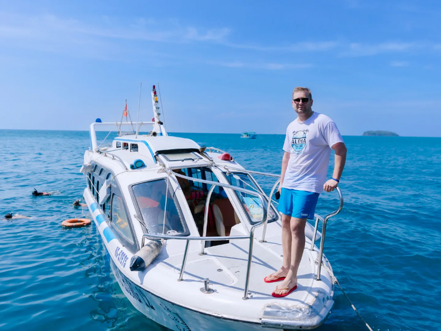 Tourist standing on speed boat exploring Phu Quoc’s 4 islands with clear blue waters and coral reefs