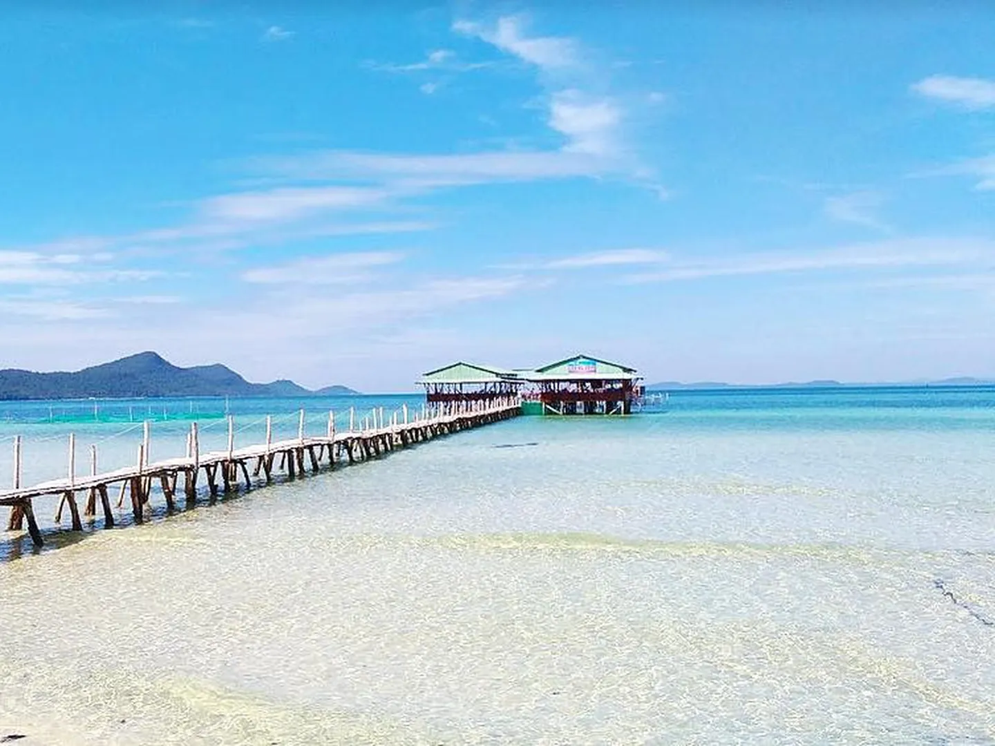 Secluded wooden pier and white sandy beach on a private custom VIP tour in Phu Quoc
