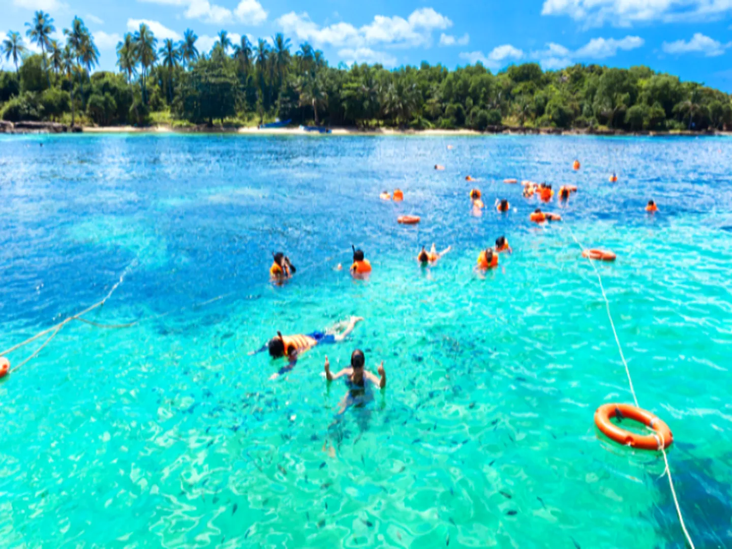 ourists snorkeling and swimming in crystal-clear waters near Phu Quoc’s three small islands
