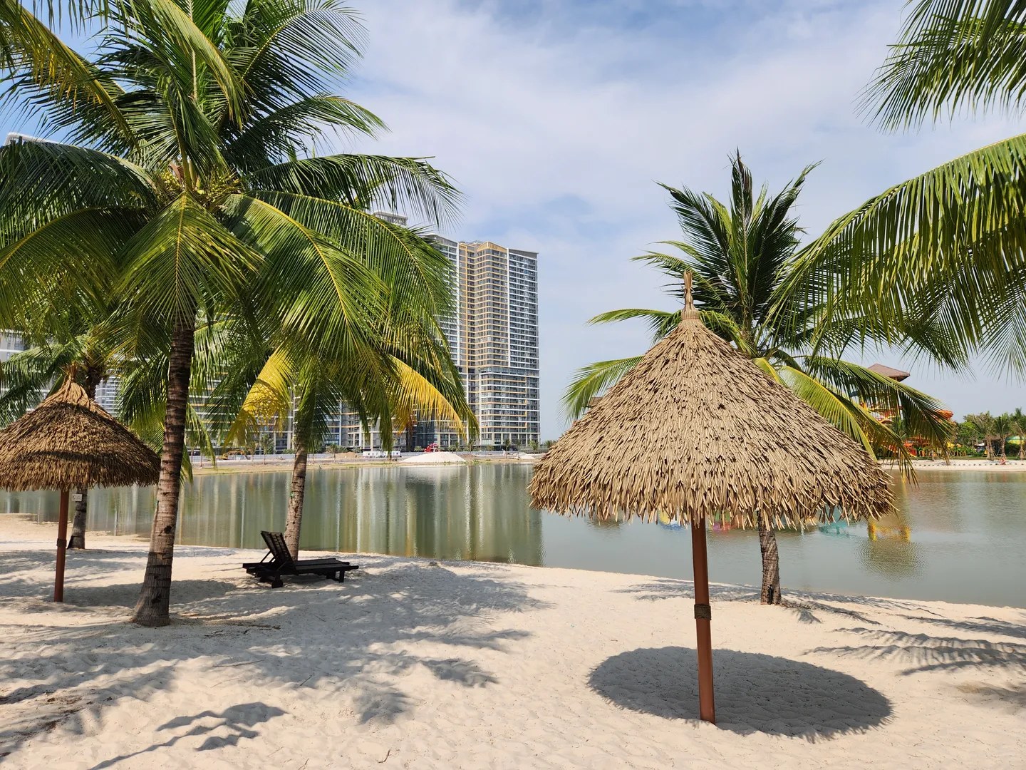  Image of a lakeside beach with sun shelters in Grand Park in Ho Chi Minh City-a popular tourist destination in Vietnam 