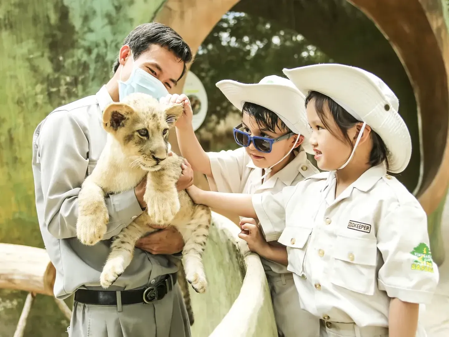  Kids are interacting with animals as a part of a guided Junior Zoo Keeper Program in Safari Phu Quoc theme park-a popular tourist destination in Vietnam 