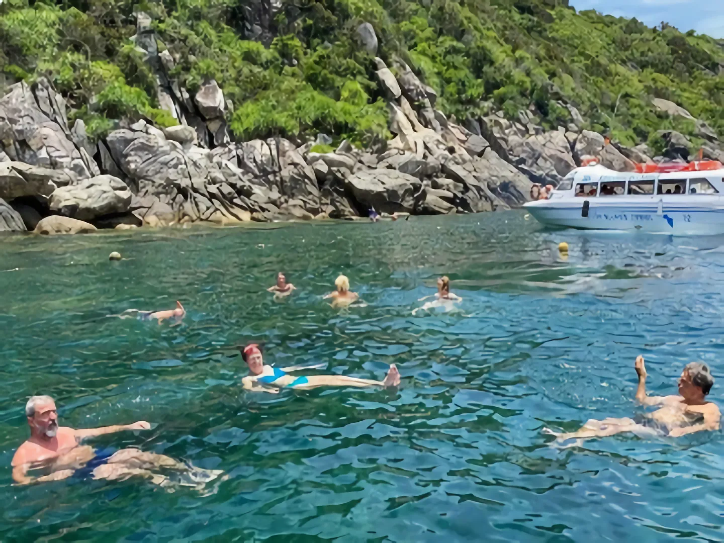 Swimmers enjoying the tropical beach with turquoise water on Cham Island off Hoi An, a popular holiday destination in Vietnam