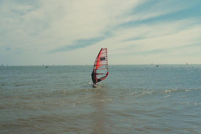  A wind surfer riding a wave near a beach in Mui Ne-a popular surfing destination in Vietnam 